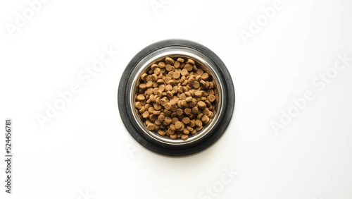 The metal pet bowl with dry food on white background