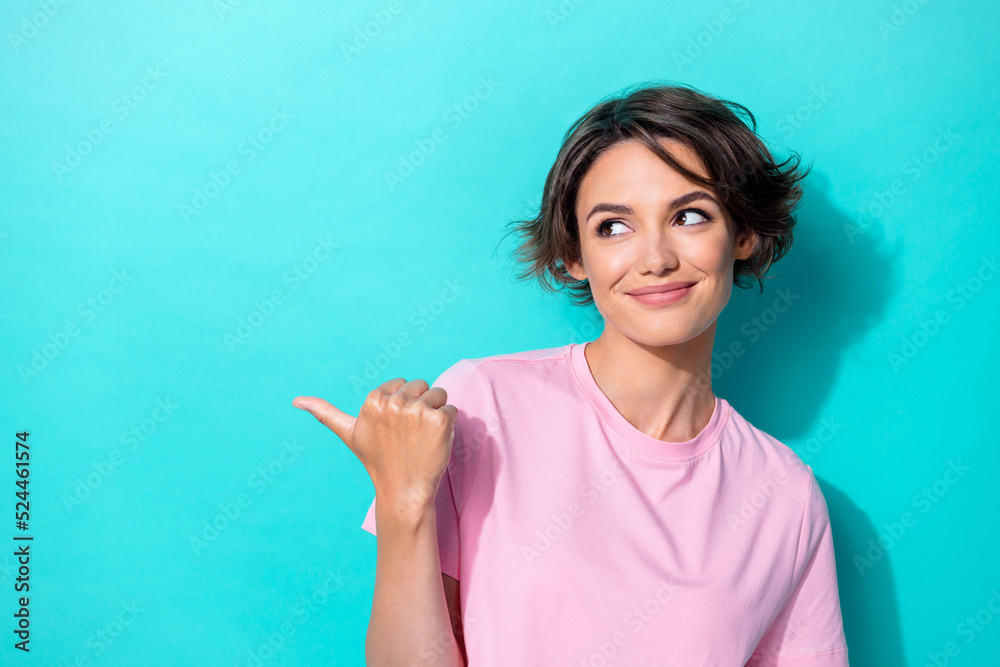Photo of lovely short hairdo millennial lady indicate look empty space wear pink t-shirt isolated on turquoise color background Photo of lovely short hairdo millennial lady indicate look empty space wear pink t-shirt isolated on turquoise color background
