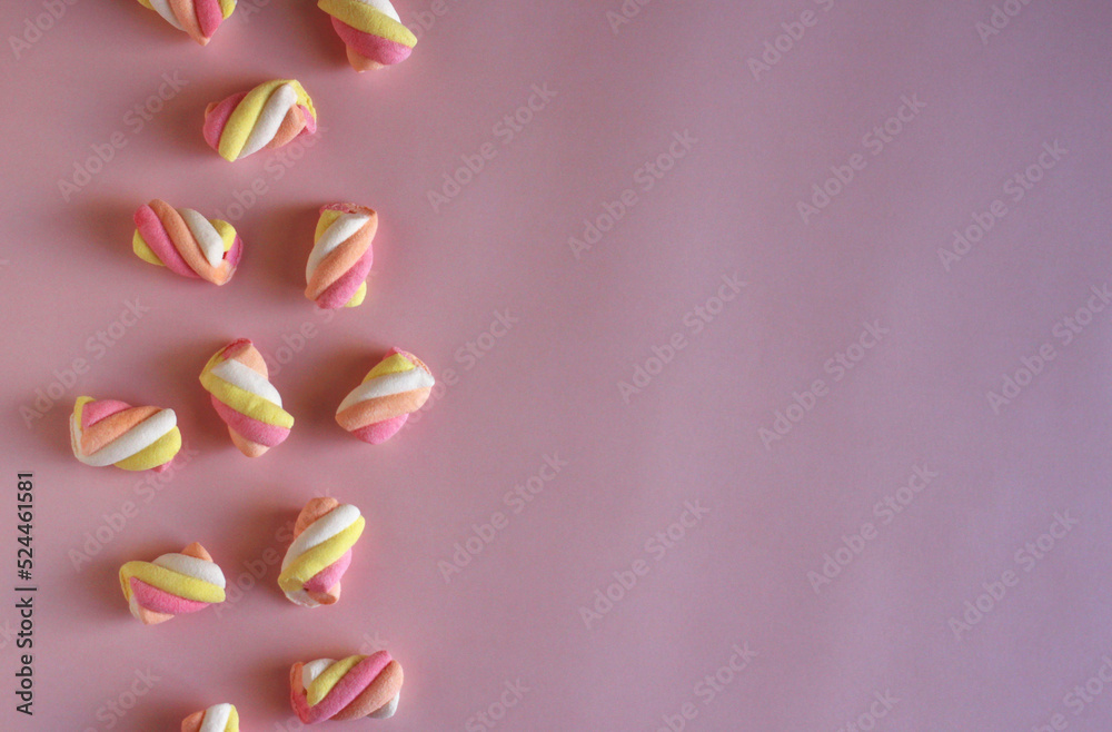 dessert multi-colored air marshmallows on a pink background