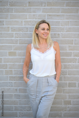 Happy relaxed trendy blond woman in summer fashion