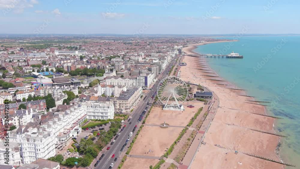 Eastbourne, UK: Aerial view of city in England, wide beach and famous Eastbourne Pier in summer seaside resort by Atlantic Ocean, sunny day - landscape panorama of United Kingdom from above Eastbourne, UK: Aerial view of city in England, wide beach and famous Eastbourne Pier in summer seaside resort by Atlantic Ocean, sunny day - landscape panorama of United Kingdom from above