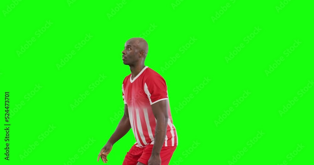 Video of african american male soccer player kicking ball on green screen background