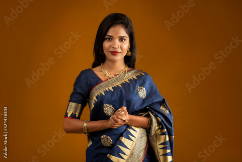 Portrait of a young girl or woman posing on brown background