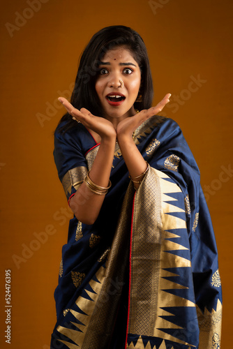 Portrait of a young girl or woman posing on brown background
