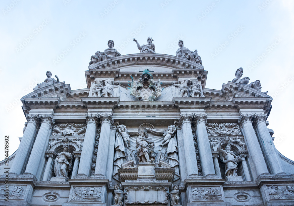 Facade of an ancient building with columns and statues at Venice, Veneto, Italy.