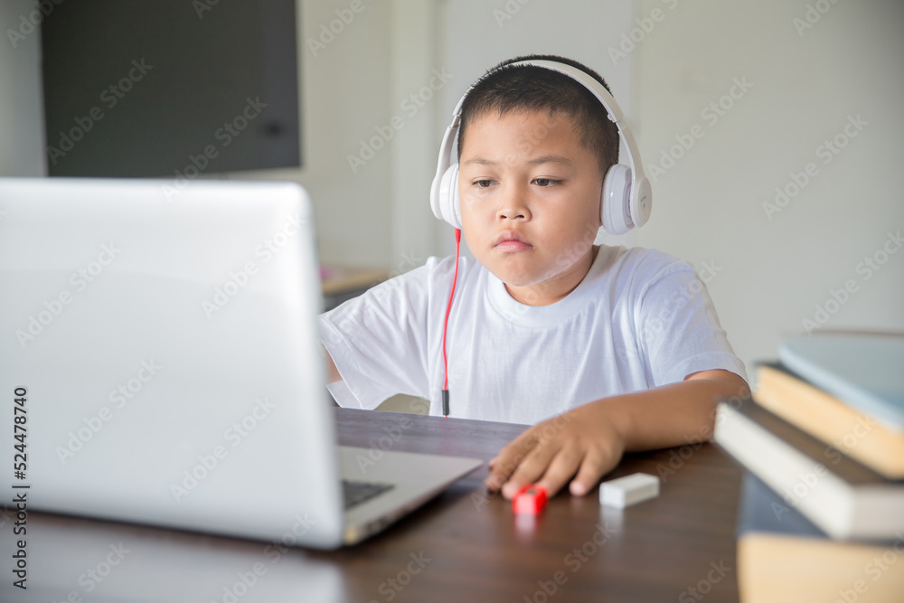 Young student distance learning virtual distance online class on video call virtual lesson, technology studying at home using laptop computer. Parent or tutor teaching child boy with remote education. Young student distance learning virtual distance online class on video call virtual lesson, technology studying at home using laptop computer. Parent or tutor teaching child boy with remote education.