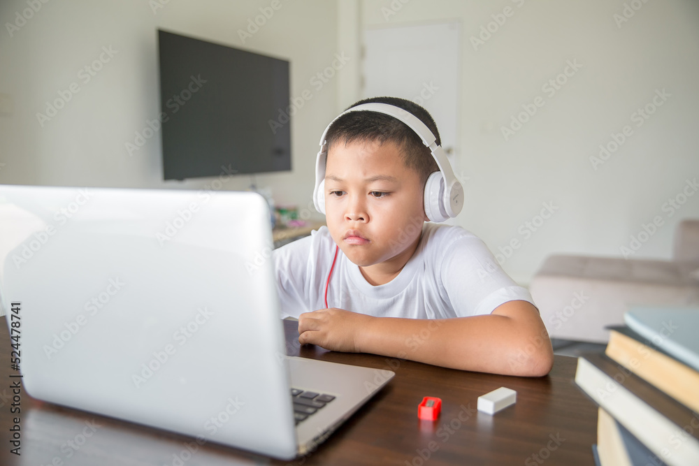 Young student distance learning virtual distance online class on video call virtual lesson, technology studying at home using laptop computer. Parent or tutor teaching child boy with remote education. Young student distance learning virtual distance online class on video call virtual lesson, technology studying at home using laptop computer. Parent or tutor teaching child boy with remote education.