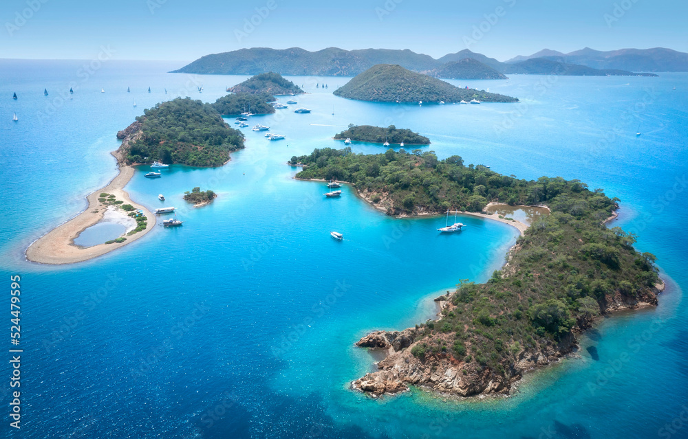 Beautiful landscape aerial view of turkish islands near Fethiye. Lots of sport yachts near islands with open sails.