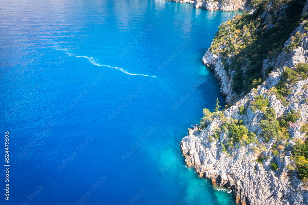 Summer landscape of rocky coast in sunrise. Part of turkish coast near Fethiye. Blue lagoon among rocks.