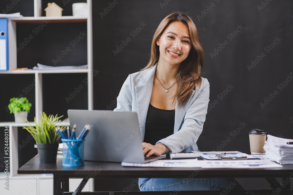 Smiling Asian businesswoman working on laptop in modern office Accountant Concept Finance Expert Analyze Business Report Graph financial chart financial chart corporate economy Banking Market Research Smiling Asian businesswoman working on laptop in modern office Accountant Concept Finance Expert Analyze Business Report Graph financial chart financial chart corporate economy Banking Market Research