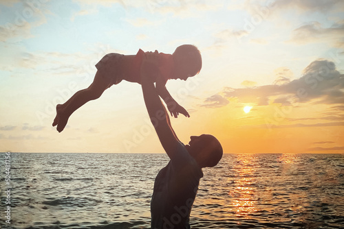 The shadow of the father and child against the sunset.