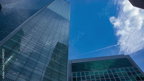 A timelapse of cloud reflecting the building in the business town wide shot tilt