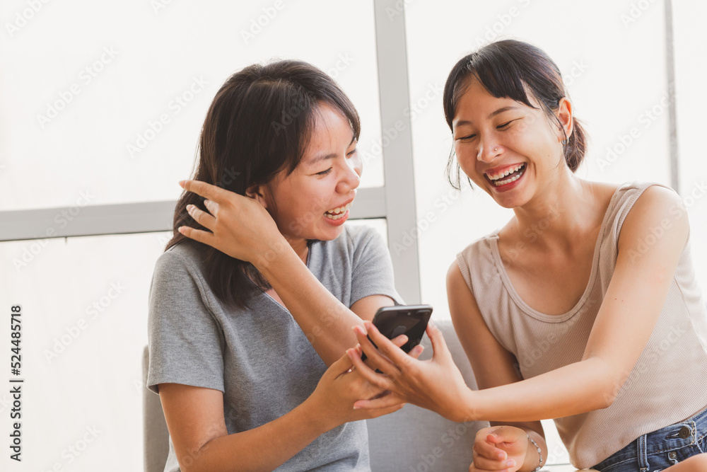 Young happy attractive Asian teenager students taking selfie with friend indoor coffee cafe. Cheerful girl friends taking photos together with happy fun moment. LGBT lesbian couple life style concept. Young happy attractive Asian teenager students taking selfie with friend indoor coffee cafe. Cheerful girl friends taking photos together with happy fun moment. LGBT lesbian couple life style concept.