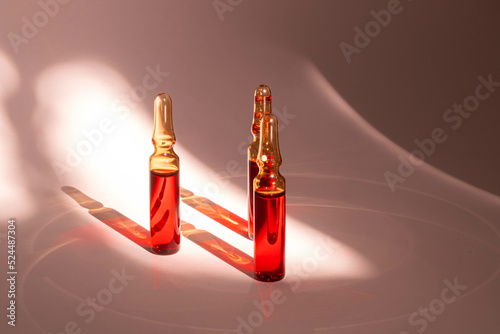 injections of B vitamins. Ampoules with red liquid. Beauty and health concept photo