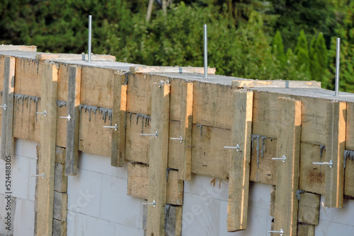 A reinforced concrete beam and a wooden formwork on the first floor of a house under construction, walls made of autoclaved aerated concrete photo