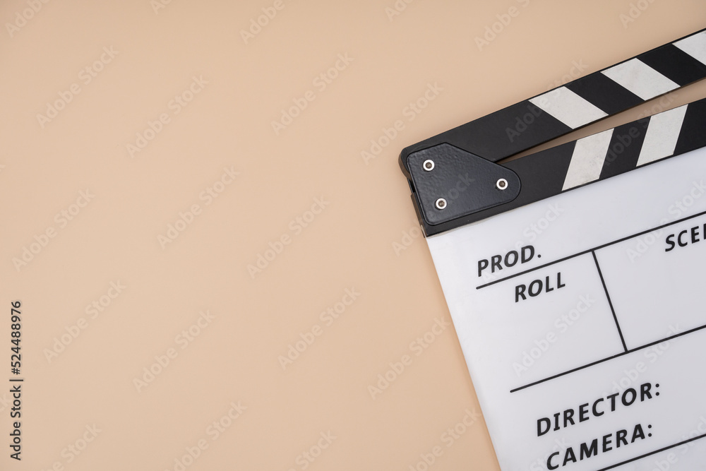 movie clapper on yellow table background ; film, cinema and video photography concept