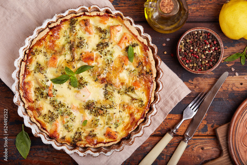 Quiche open tart pie with salmon fish and broccoli. Savory taste. Top view