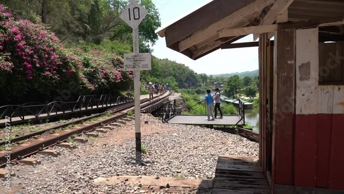Tourist are traveling in Death railway bridge in Kanchanaburi Thailand.