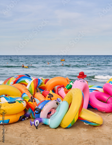 My Khey Beach, Danang Vietnam, a vendor offers inflatable beach toys at a beach.