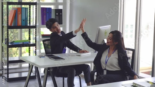 Business couple putting hand Hi Five together for success in office co working.