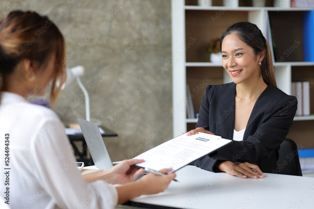 Female manager in office discussing and interviewing job applicant for new employees. Female manager in office discussing and interviewing job applicant for new employees.