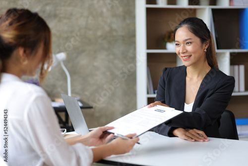 Foto Female manager in office discussing and interviewing job applicant for new employees