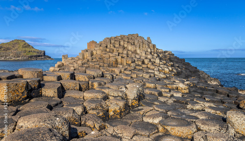 Mountain of hexagonal basalt columns of Giant's Causeway UNESCO World Heritage Site, is an area of about 40,000 interlocking , the result of an ancient volcanic fissure eruption