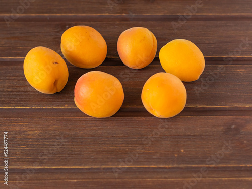 ripe fresh apricots on a wooden table