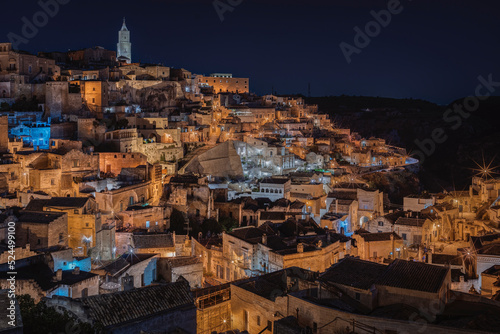 Matera by night, photos from the panoramic terrace. Photo from June 2022. You can see the basilica overlooking the town and the characteristic houses carved into the rock. Matera was the European capi