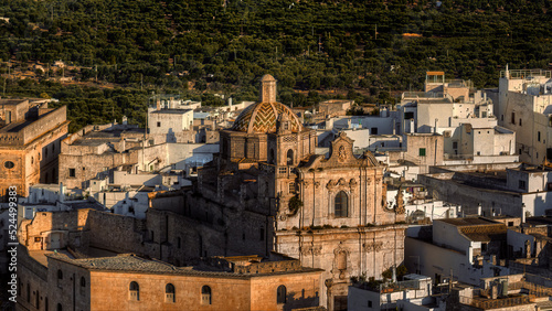 Overview of Ostuni (BR), the white city perched on the hill, with the typical white houses. Aerial photo with the drone of June 2022 photo taken at dawn.