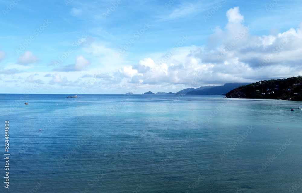 Beautiful panoramic landscape with clear blue ocean water and mountains on coast on Seychelles islands