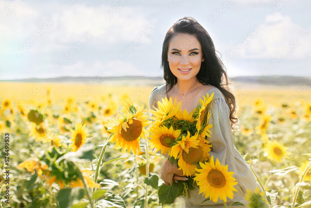 a beautiful, happy brunette girl in a field with blooming sunflowers. Summer. Rural area. a beautiful, happy brunette girl in a field with blooming sunflowers. Summer. Rural area.