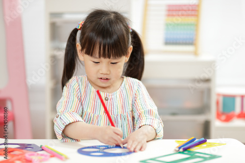 young girl practice drawing different shapes for homeschooling