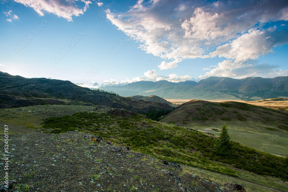 Steppe against the backdrop of mountains in the sunset light Steppe against the backdrop of mountains in the sunset light