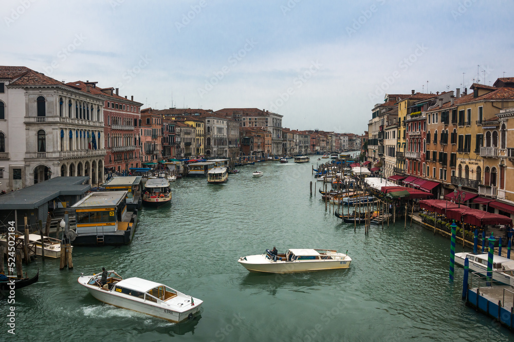 A beautiful view of the Grand Canal and boats and ancient buildings at Venice, Veneto, Italy.