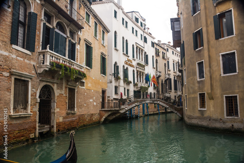 Narrow canal and bridge and ancient buildings at Venice  Veneto  Italy.