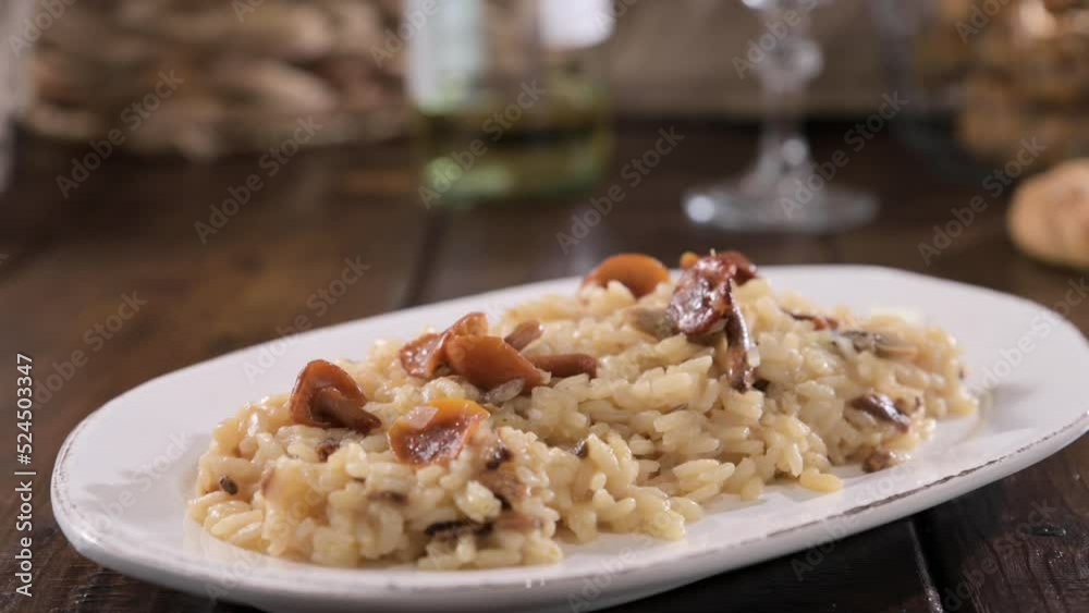 risotto with porcini mushrooms. Risotto with porcini mushrooms.Typical Italian food white rice with mushrooms in parmesan sauce. Antipasto for dinner. High quality 4k footage risotto with porcini mushrooms. Risotto with porcini mushrooms.Typical Italian food white rice with mushrooms in parmesan sauce. Antipasto for dinner. High quality 4k footage
