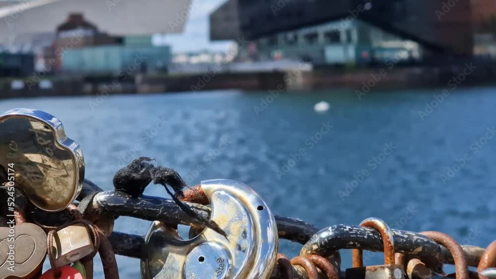 Modern and classic architecture is revealed behind love padlocks at the