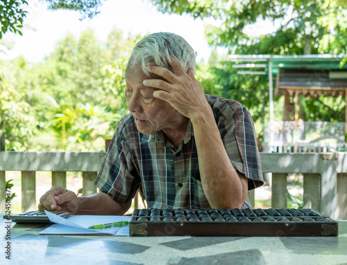 Old man using wooden Chinese abacus photo