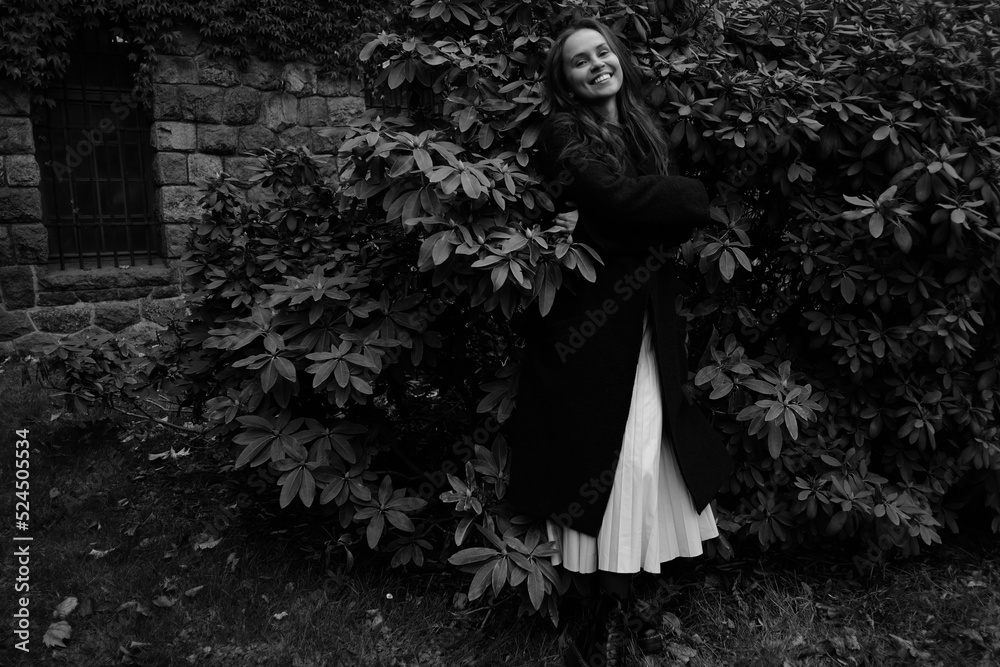 Yong girl in the autumn park on the background of plant leaves. Black and white emotional portraits Yong girl in the autumn park on the background of plant leaves. Black and white emotional portraits