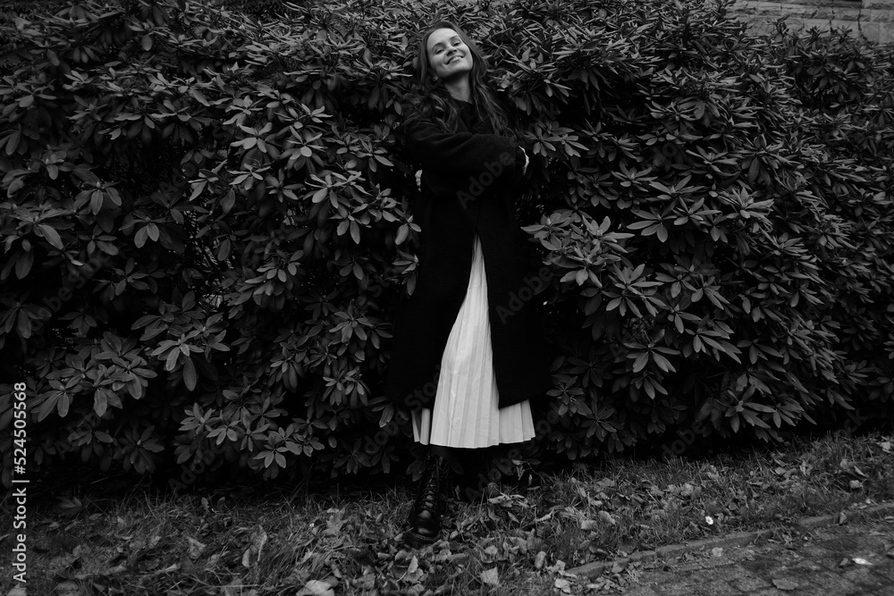 Yong girl in the autumn park on the background of plant leaves. Black and white emotional portraits Yong girl in the autumn park on the background of plant leaves. Black and white emotional portraits