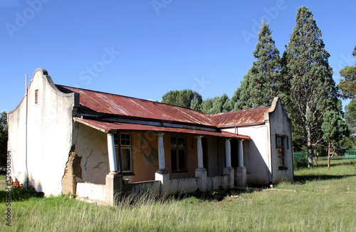 Photo of abandoned old houses and buildings in South Africa, red stone, mud and stone walls © Elizabeth Lombard