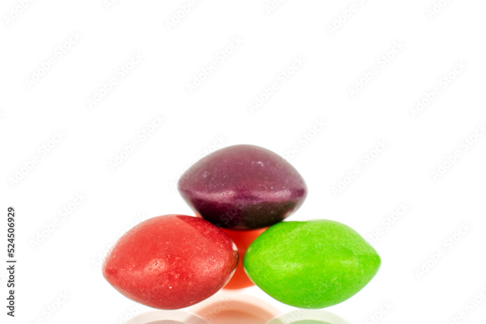 Three sweet colored candies, close-up, isolated on a white background. Three sweet colored candies, close-up, isolated on a white background.