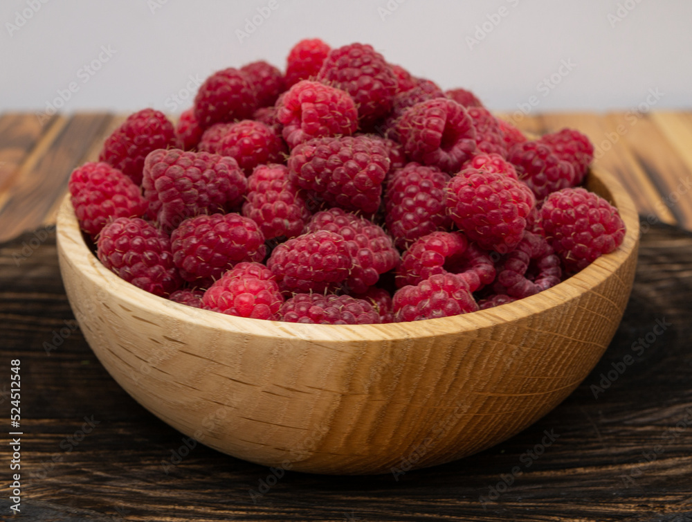 Raspberries in wooden bowl. Raspberry with copy space for text Raspberries in wooden bowl. Raspberry with copy space for text