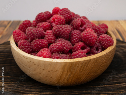 Raspberries in wooden bowl. Raspberry with copy space for text