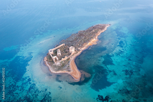 Cunda Paterica bay pigeon island ruins of an old hospital building and beautiful blue sea aerial drone view