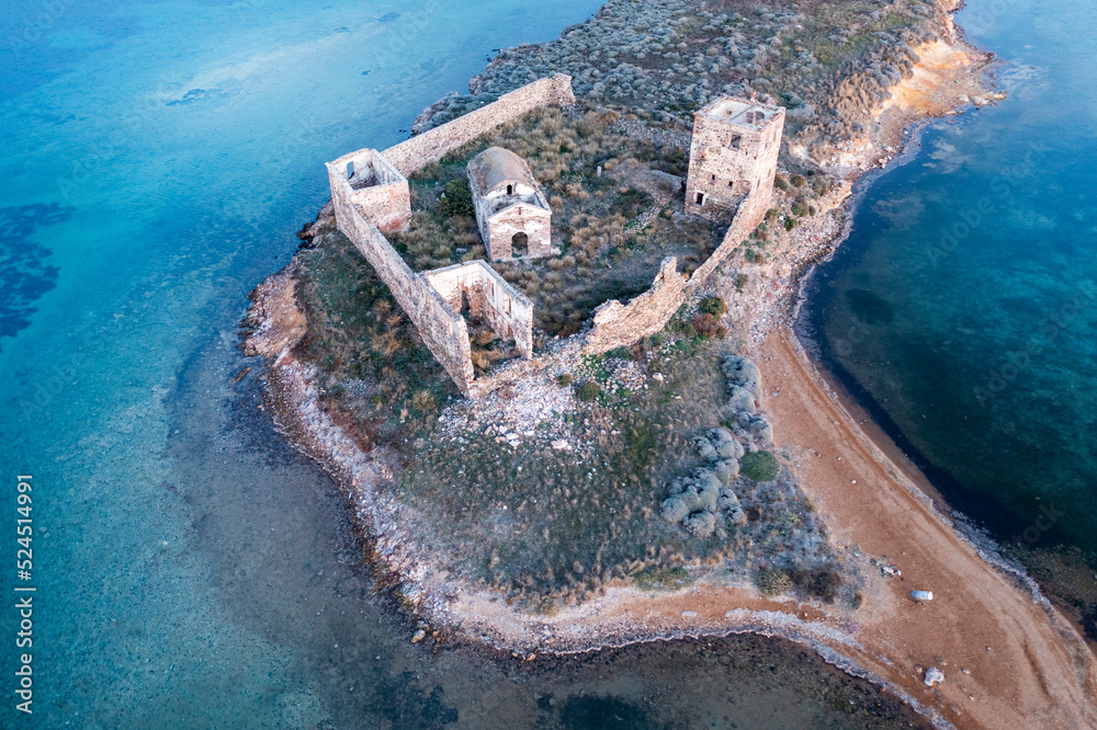 Cunda Paterica bay pigeon island ruins of an old hospital building and beautiful blue sea aerial drone view