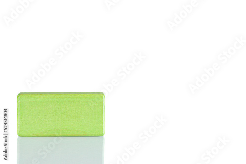 Wooden cube of green color on a white background