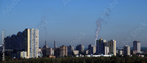 Fire and smoke on the background of city buildings © SERHII BLIK