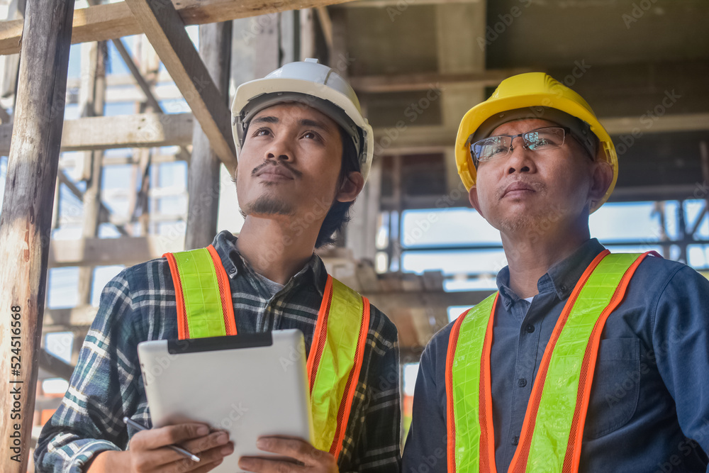 Team engineer Two man architect on a building construction site Team engineer Two man architect on a building construction site